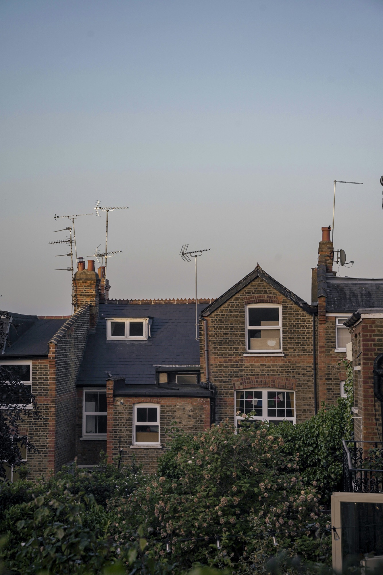 London slate roofline with dormer windows at dusk